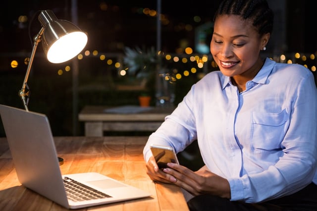 Businesswoman using mobile phone at her desk in the office.jpeg